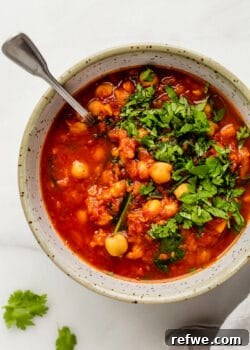 Moroccan chickpea stew in a white speckled bowl