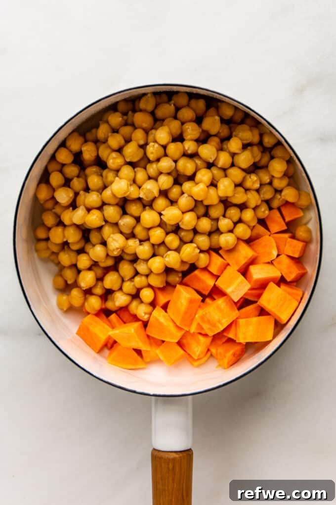 Fragrant Moroccan Chickpea Stew 4 Cubed sweet potatoes and chickpeas added to the pot with sautéed aromatics, ready for the next ingredients.