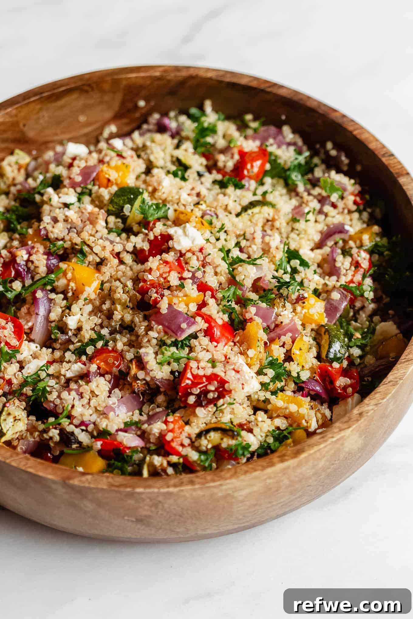 Vibrant Roasted Vegetable Quinoa Salad 2 A vibrant roasted vegetable quinoa salad served in an elegant wood bowl, ready to be enjoyed.