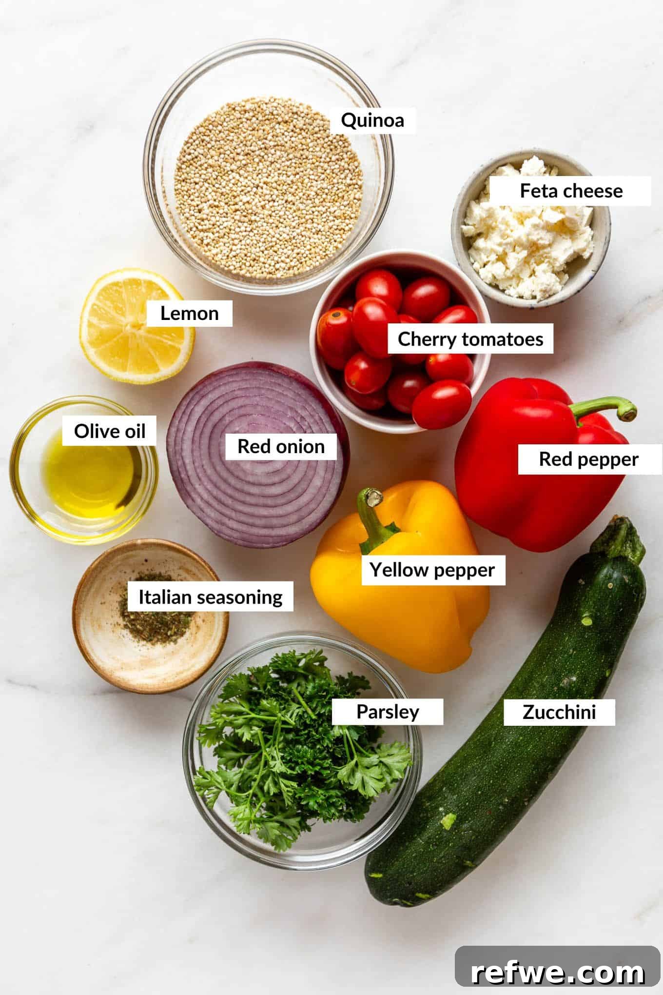 Vibrant Roasted Vegetable Quinoa Salad 3 A flat lay photograph showcasing fresh ingredients for roasted vegetable quinoa salad on a white background.