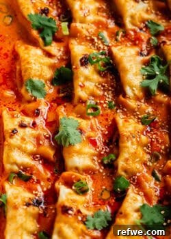 Baked curry dumplings topped with cilantro and sesame seeds, presented in an appealing culinary shot.