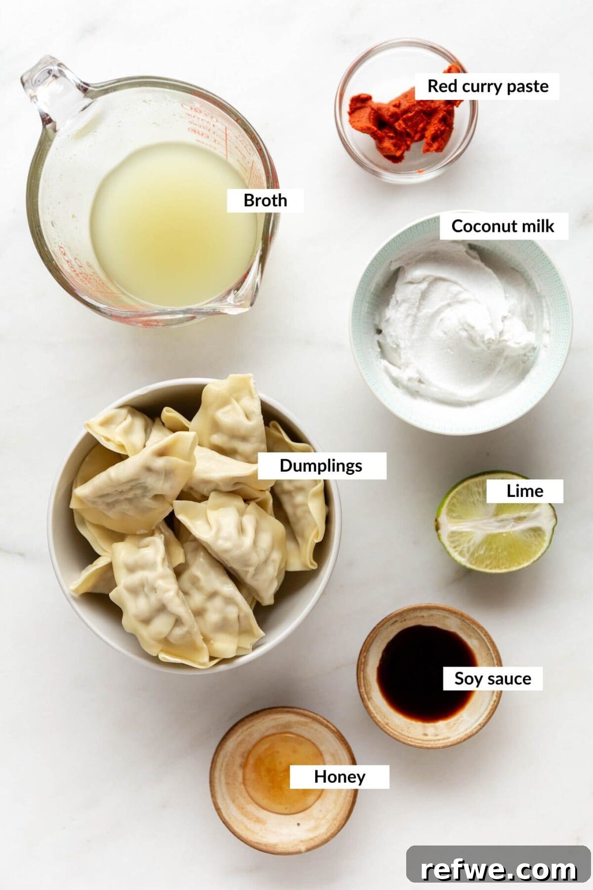 Sheet Pan Dumpling Bake 3 Individual ingredients laid out for baked dumplings recipe, including coconut milk, curry paste, broth, and a package of dumplings.