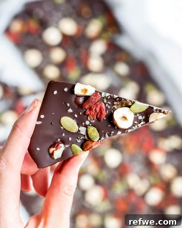 Glow-Boosting Chocolate Bark 4 Assorted pieces of Superfood Chocolate Bark on a wooden board