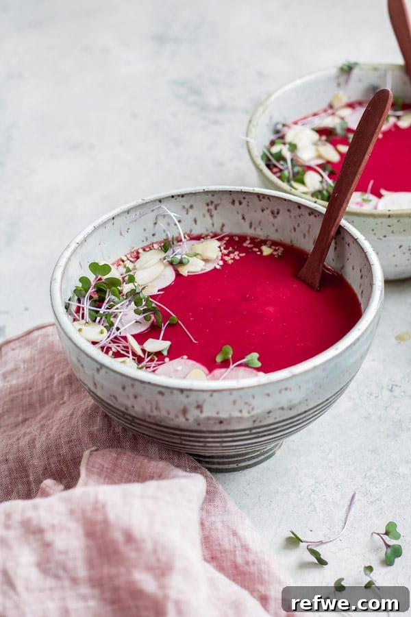 Hearty Vegan Beet Potato Leek Soup 5 A side view of a bowl of vegan beet, potato, and leek soup, highlighting its creamy texture.