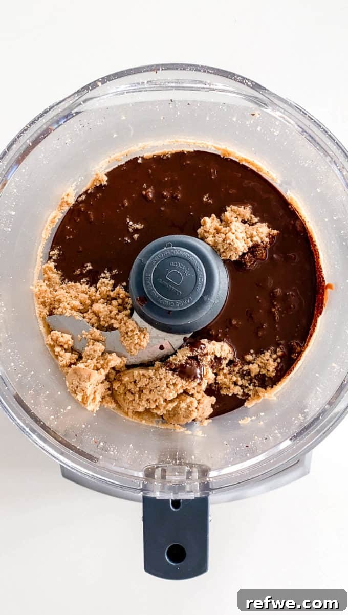Plant-Based Hazelnut Cacao Dream 11 Hazelnut butter, melted chocolate, maple syrup, and salt added to the food processor.
