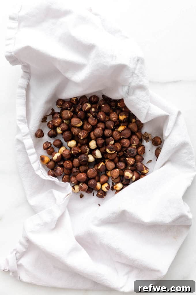 Plant-Based Hazelnut Cacao Dream 4 Roasted hazelnuts cooling in a white dish towel.