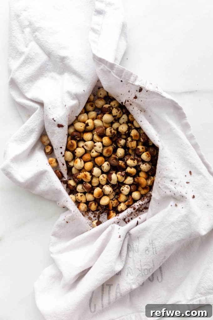 Plant-Based Hazelnut Cacao Dream 6 Cleaned hazelnuts with skins mostly removed, gathered in a white dish towel.