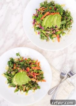 A beautifully presented Asian Kale Salad with vibrant vegetables and a rich peanut dressing, ready to be enjoyed.