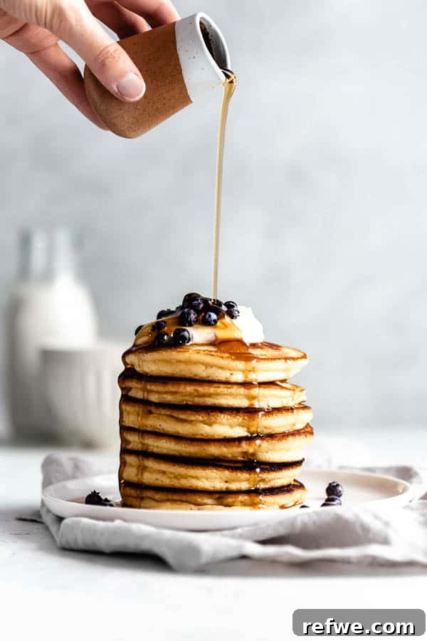 Your First Perfect Plate: Food Photography Basics 7 a stack of fluffy almond flour pancakes with a drizzle of maple syrup, captured with soft, inviting light.