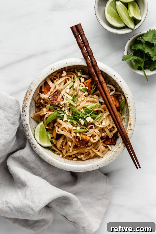 Your First Perfect Plate: Food Photography Basics 9 A bowl of vegan pad thai with tofu, meticulously styled and captured with sharp focus and inviting colors.