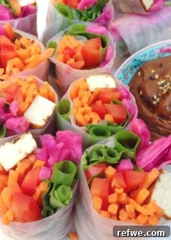 Beautifully arranged Rainbow Spring Rolls with vibrant vegetables and golden tofu