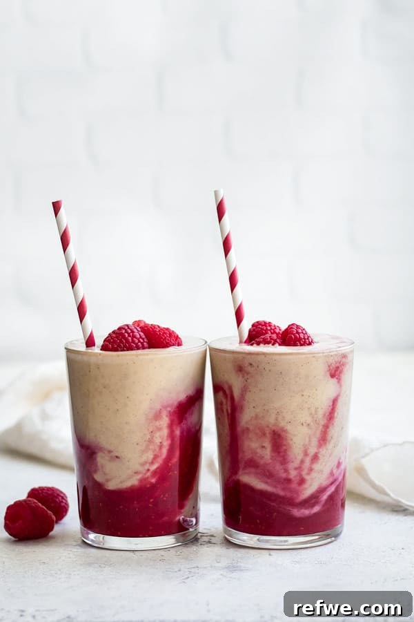 Berry Peanut Butter Bliss 4 Close-up of a vibrant, layered peanut butter and jelly smoothie, with focus on the distinct colors and creamy textures.