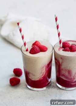 Layered peanut butter and jelly smoothie with raspberries