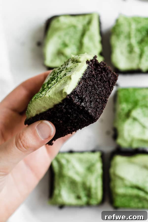 Cool Matcha Mint Swirl Almond Brownies 3 gluten free almond flour brownies with matcha frosting being held