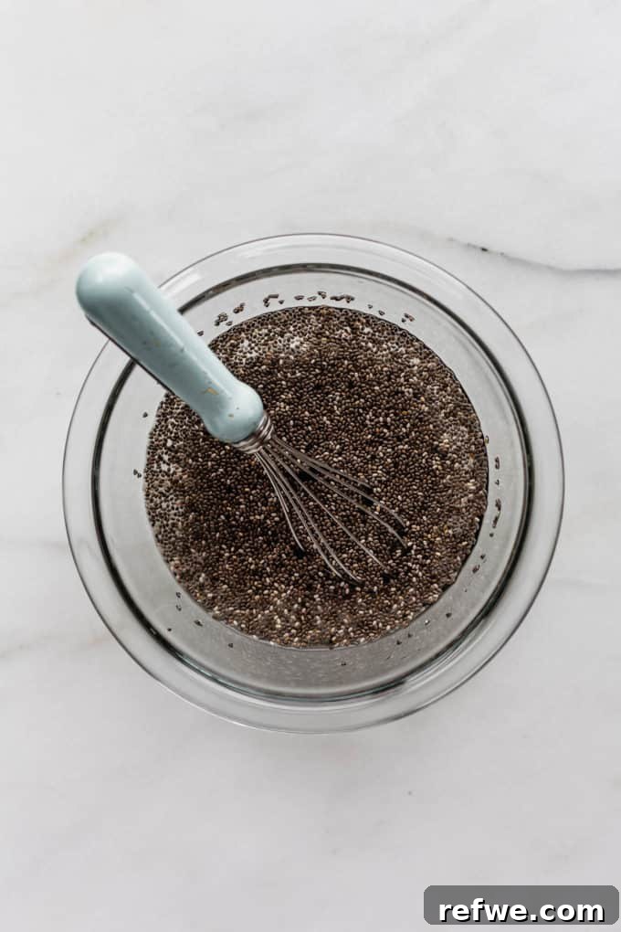 Wholesome Chia Buckwheat Loaf 3 A clear mixing bowl holds chia seeds and water, ready to be whisked and transformed into a gel for the bread recipe.