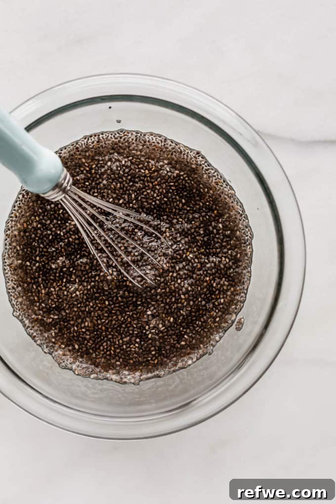 Wholesome Chia Buckwheat Loaf 4 The same clear mixing bowl now contains gelled chia seeds, showcasing their thickened, translucent texture after absorbing water, prepared for mixing into the bread dough.