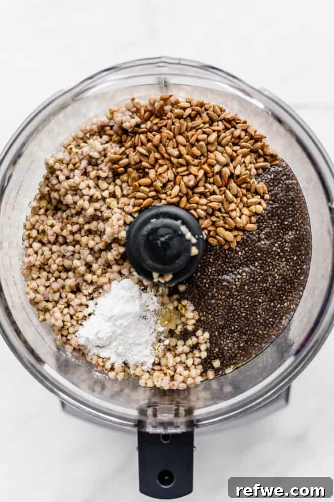 Wholesome Chia Buckwheat Loaf 5 A food processor bowl filled with dry ingredients: buckwheat groats, sunflower seeds, and baking powder, alongside the prepared chia seed gel, ready for blending.