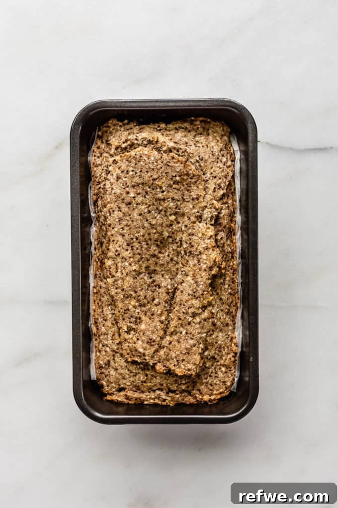 Wholesome Chia Buckwheat Loaf 8 A freshly baked loaf of buckwheat chia bread, golden brown and firm, cooling in its loaf pan after removal from the oven.