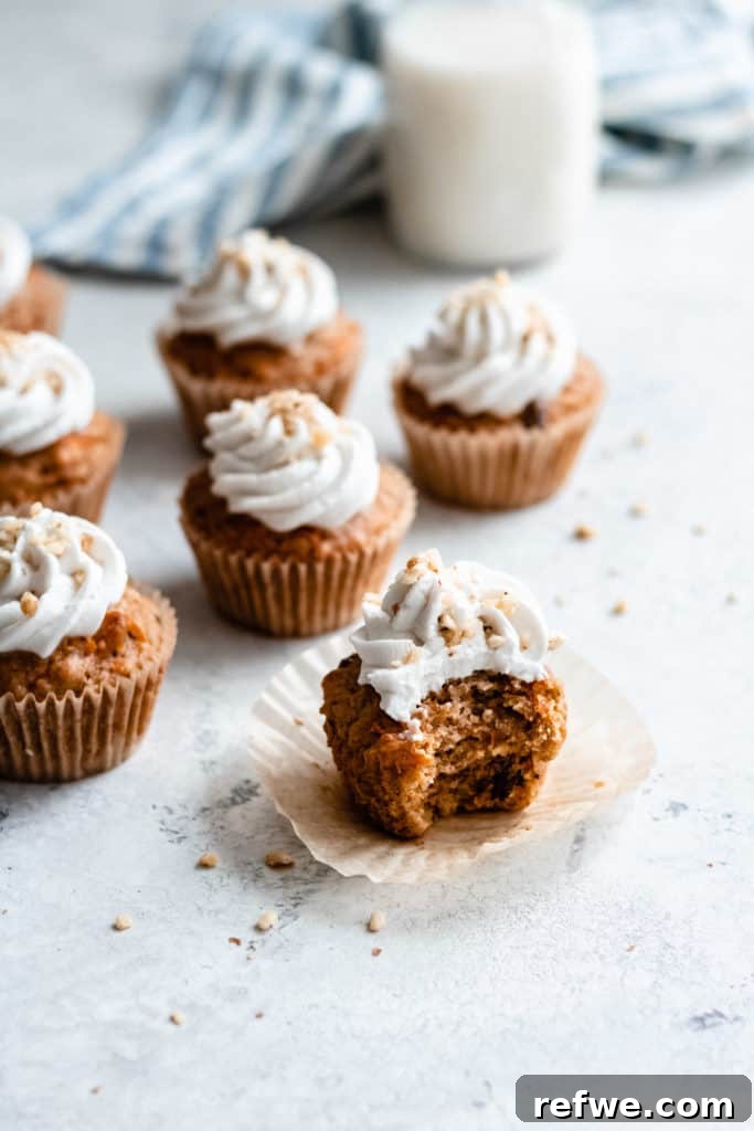 Irresistible Vegan Carrot Cupcakes 4 A batch of freshly baked vegan carrot cake cupcakes cooling on a wire rack, ready for their luxurious coconut whipped cream topping.