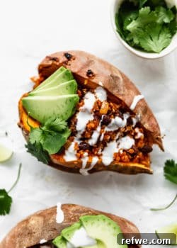 A black bean and quinoa stuffed sweet potato with sour cream and avocado on it, featured as the main recipe image.