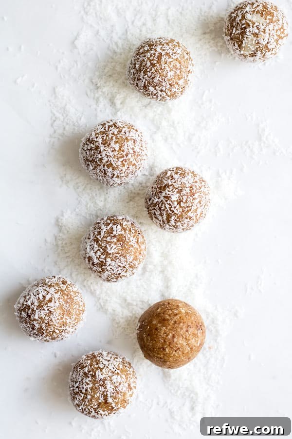 Irresistible Salted Caramel Coconut Bites 3 Close-up of salted caramel coconut bliss balls, showing their soft texture and coconut coating, artfully arranged on a rustic surface.
