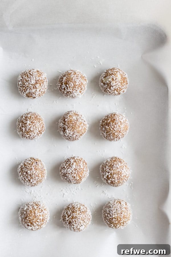 Irresistible Salted Caramel Coconut Bites 4 A top-down view of salted caramel coconut bliss balls, showcasing their perfectly round shape and a generous dusting of coconut, ready for enjoyment.