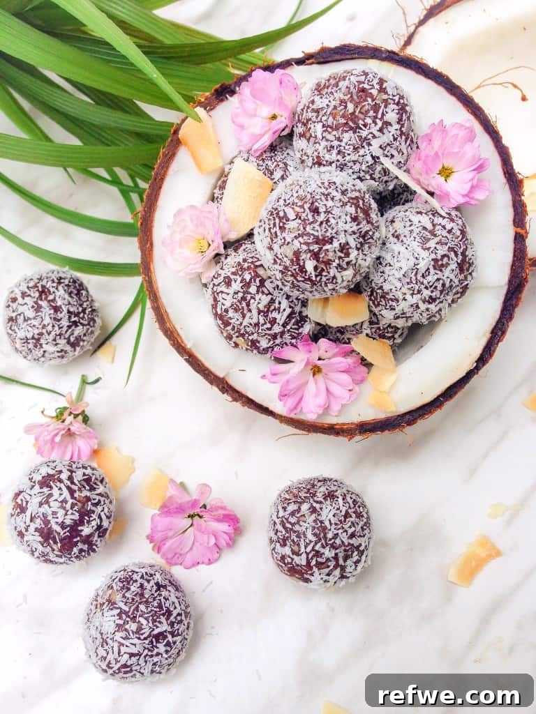 Delicious Chocolate Coconut Bliss Balls on a plate, garnished with shredded coconut