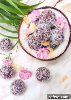Close-up of a chocolate coconut bliss ball coated in shredded coconut