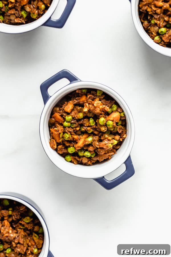 Plant-Powered Lentil Shepherd's Pie 4 The savory lentil and vegetable mixture prepared and ready in small blue ramekins