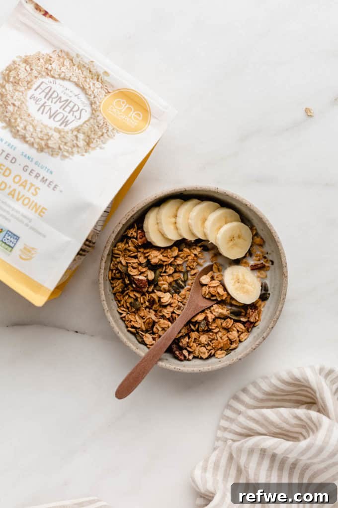 Cozy Autumn Granola 3 A rustic bowl of granola with sliced bananas and a package of One Degree Organic Sprouted Rolled Oats on the side.