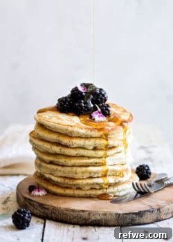 Lemon poppy seed spelt pancakes, a stack of golden deliciousness, garnished with fresh berries.