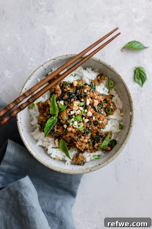 Fragrant Thai Basil Tempeh Stir-Fry 3 Close-up of freshly cooked Thai basil tempeh stir fry with bright green basil leaves and savory sauce.