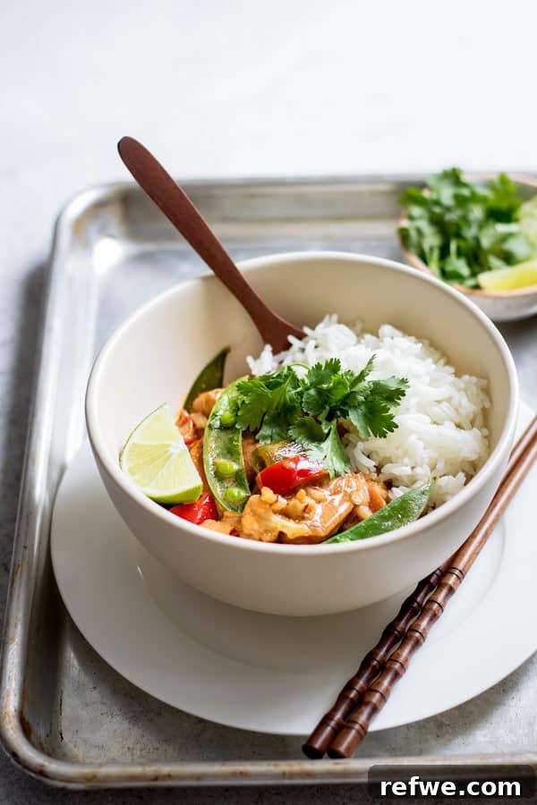 Vegetarian Thai red curry simmering in a large skillet, ready for serving.