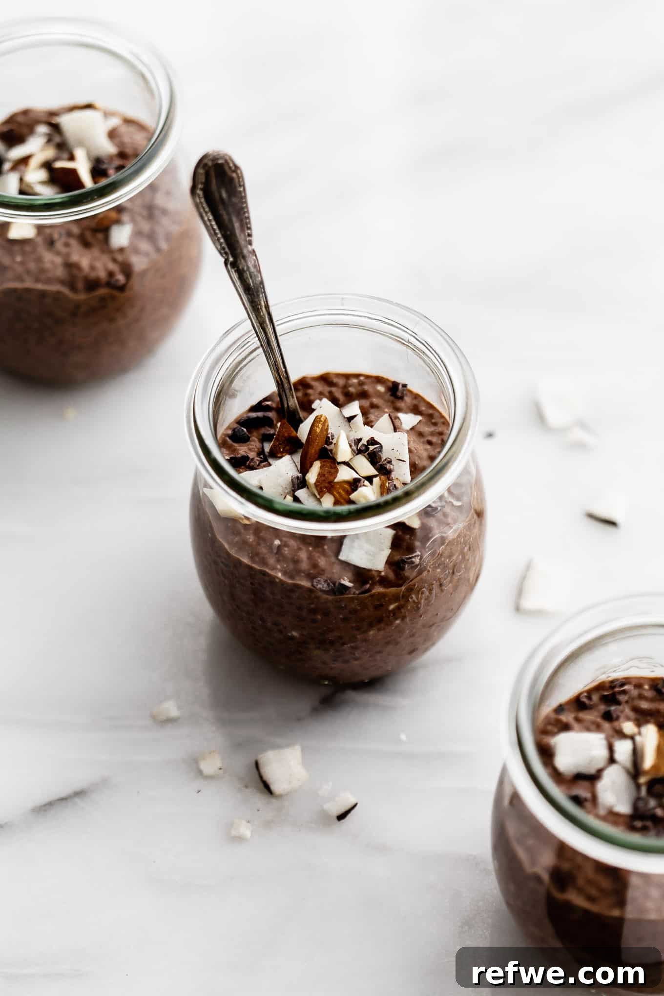 Decadent Chocolate Chia Pudding 2 Three cups of rich chocolate chia pudding, beautifully topped with shredded coconut and crunchy almonds, ready to be enjoyed as a healthy treat or breakfast.
