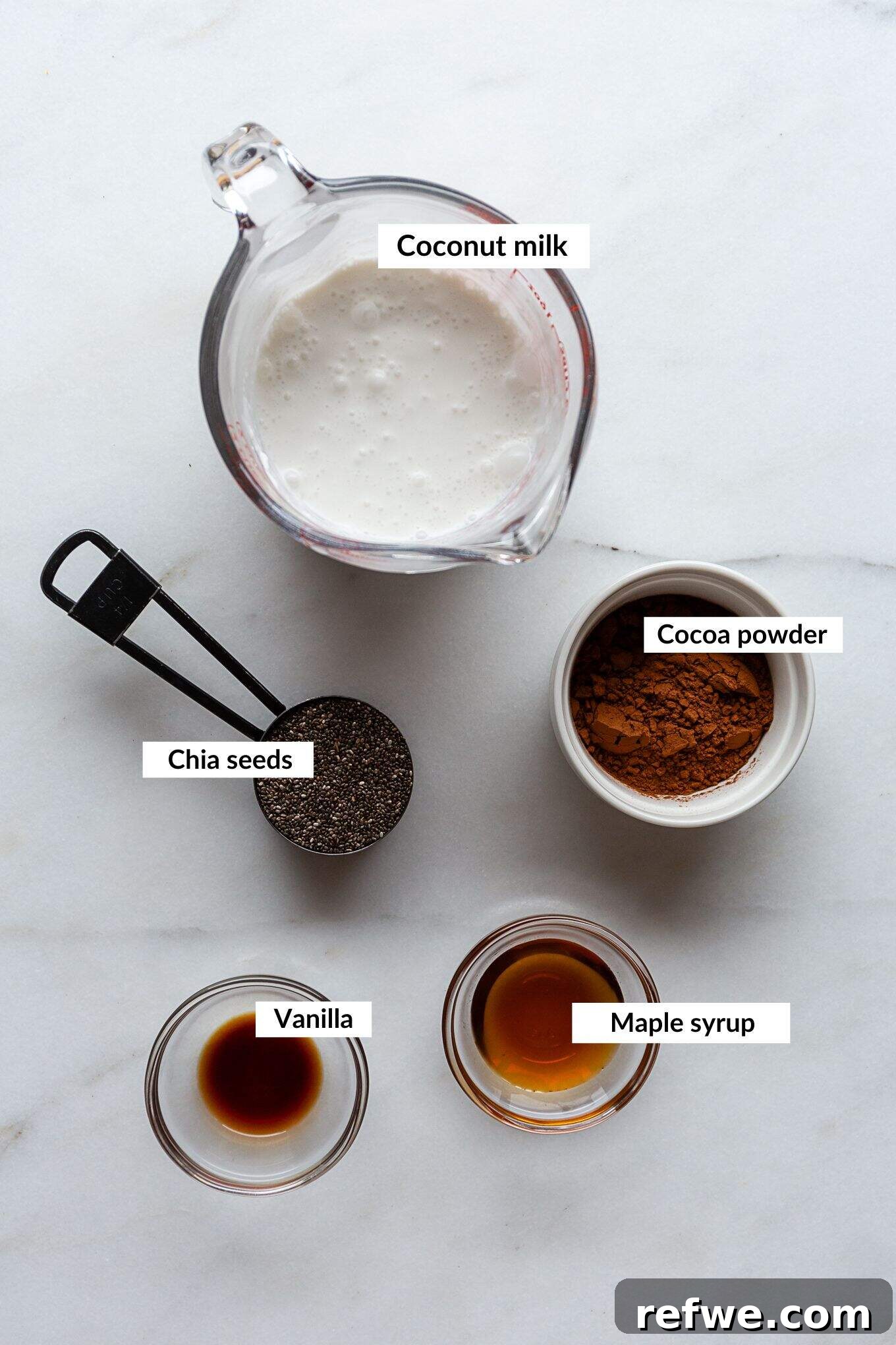 Decadent Chocolate Chia Pudding 3 A simple yet powerful collection of ingredients laid out, including chia seeds, cocoa powder, plant-based milk, and maple syrup, essential for making delicious chocolate chia pudding.
