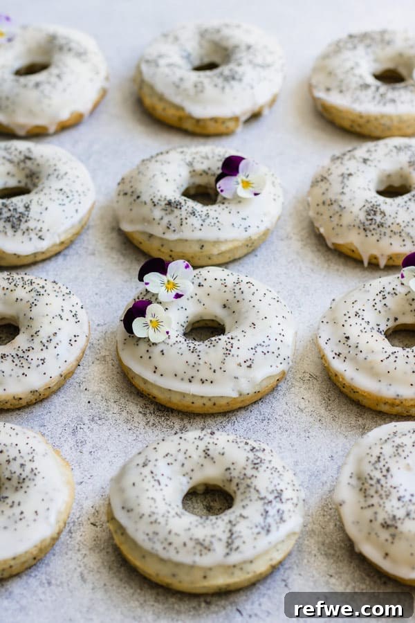 Assortment of vegan lemon poppy seed donuts on a rustic wooden board
