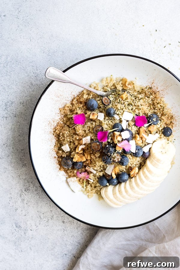 Cozy Maple Cinnamon Quinoa Breakfast 4 Overhead view of a vibrant breakfast quinoa bowl with various colorful toppings.