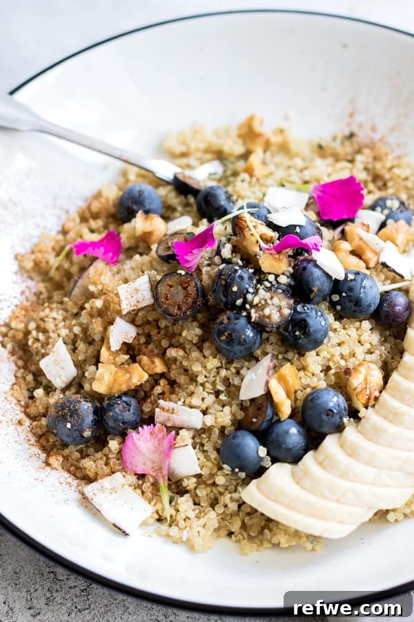 Cozy Maple Cinnamon Quinoa Breakfast 5 Side view of a healthy maple cinnamon quinoa breakfast, highlighting layers of fruit and nuts.