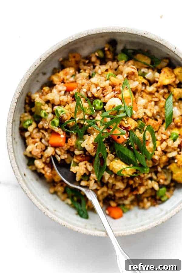 Savory Vegan Tofu Fried Rice 7 A top-down view of a generous serving of vegan fried rice, beautifully garnished with sliced green onions.