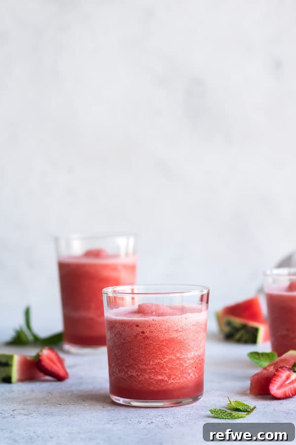 Close-up of Watermelon Mojito Frosé with mint and lime garnish