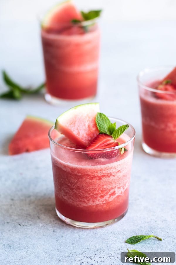Two glasses of Watermelon Mojito Frosé on a rustic table