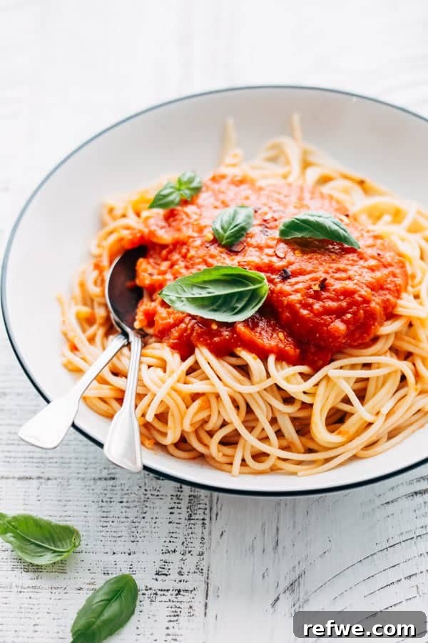 spaghetti with homemade tomato sauce, garnished with fresh basil