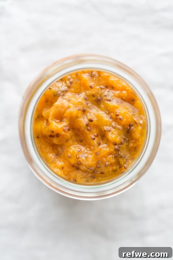 Simple Chia Seed Jam: Three Flavorful Variations 5 Close-up of blueberry chia seed jam in a jar.