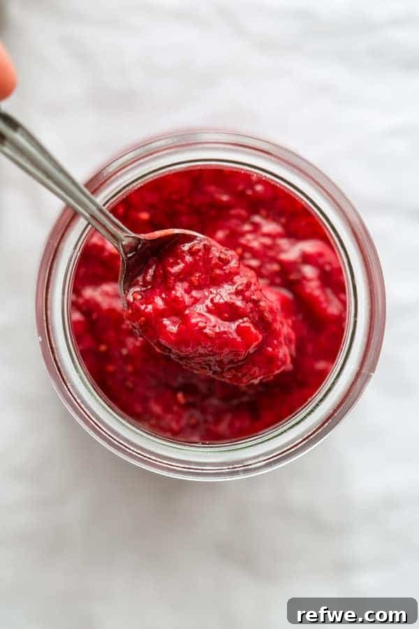 Simple Chia Seed Jam: Three Flavorful Variations 6 Three jars of chia seed jam with fresh fruit on a wooden board.