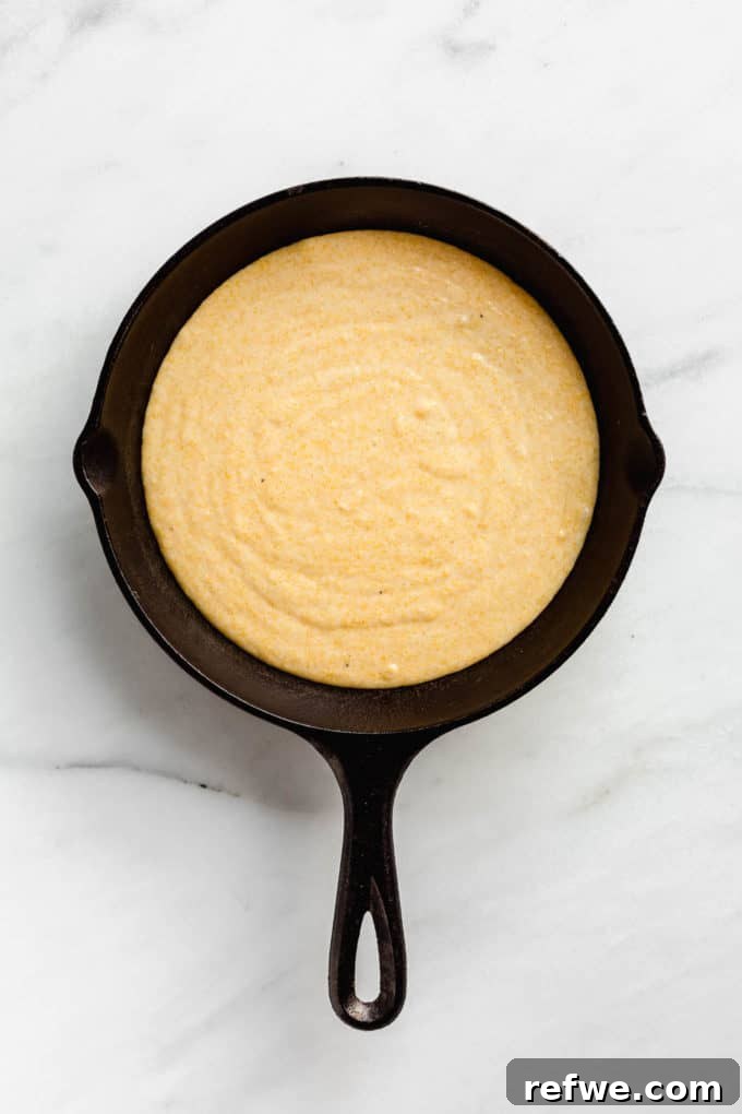 Plant-Based Cornbread 8 Unbaked vegan cornbread batter resting in a cast iron skillet, perfectly smooth and ready to be transformed in the oven.
