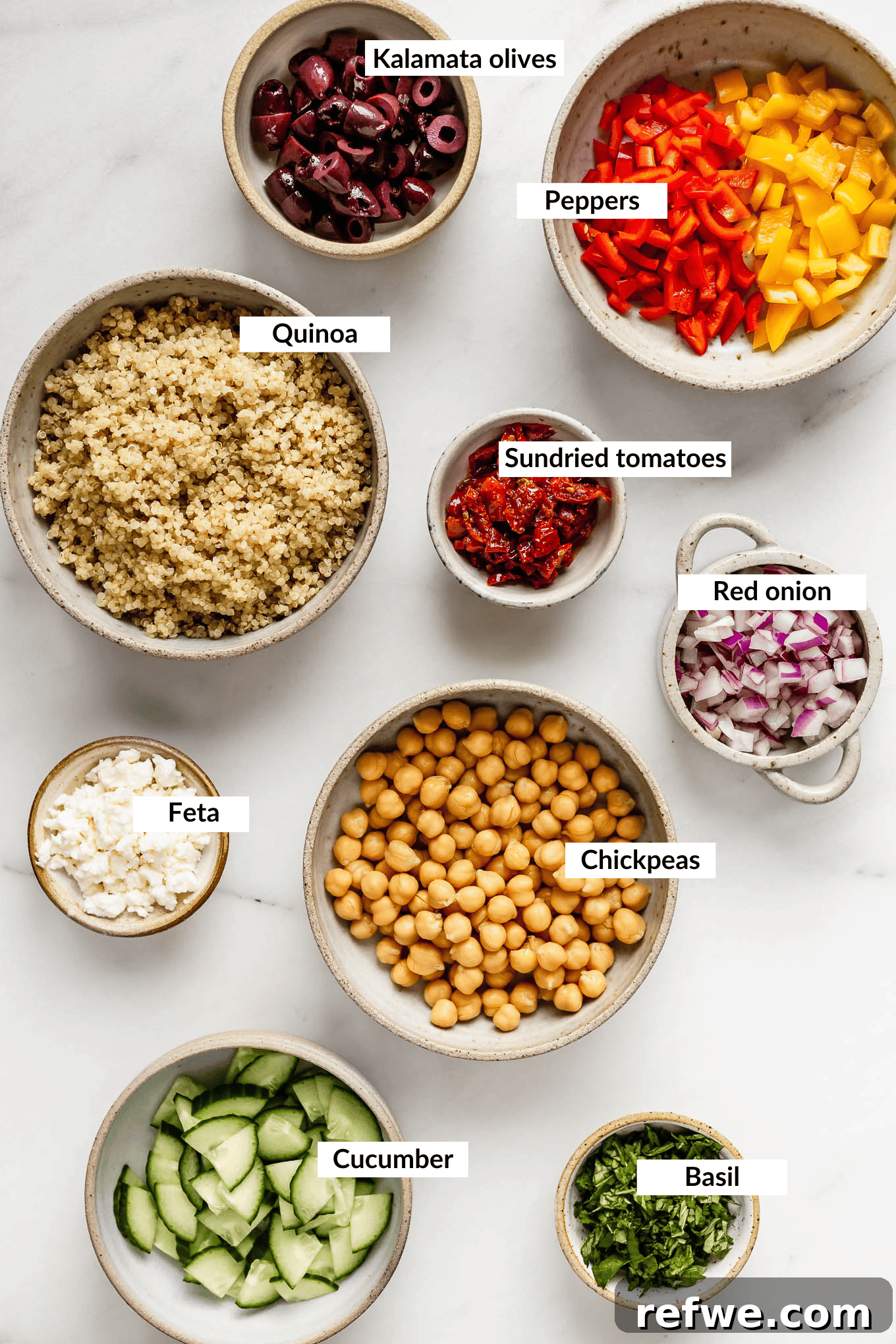 Vibrant Mediterranean Quinoa Bowl 3 A colorful array of fresh ingredients for Mediterranean quinoa salad laid out on a table.