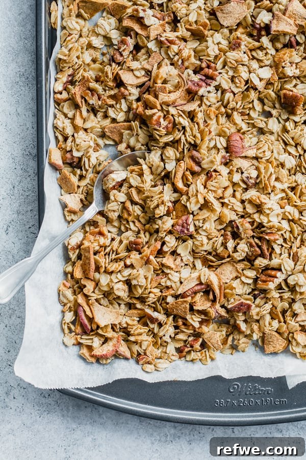 Apple Crumble Granola 3 A baking pan filled with freshly baked apple pie granola, golden brown and ready to cool.