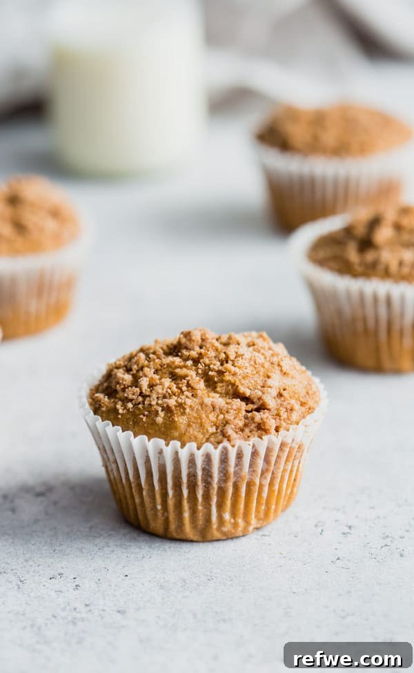 Vegan Coffee Cake Crumble Muffins 4 A bowl of muffin batter with a spoon, ready to be scooped into muffin tins, illustrating the preparation step for vegan coffee cake streusel muffins.