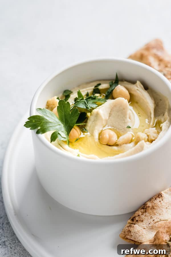 Wholesome Homemade Hummus 5 A large serving of healthy hummus on a platter with fresh ingredients