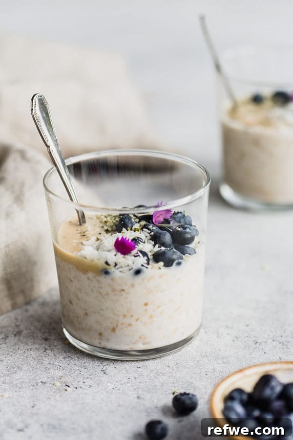 Effortless Overnight Steel Cut Oats 5 A vibrant cup of overnight steel cut oats garnished with blueberries, capturing the essence of a wholesome and appealing breakfast.